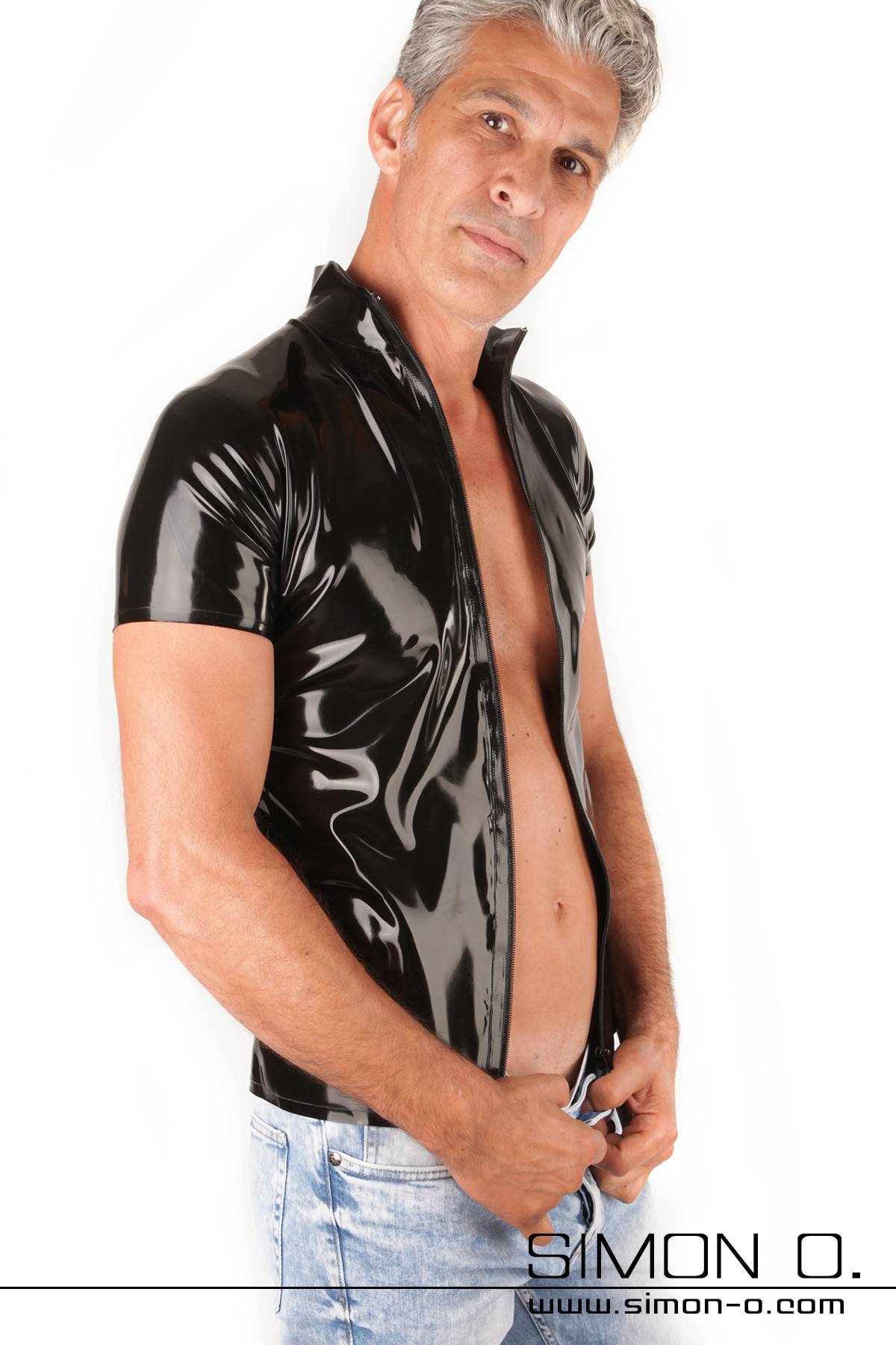 A man wears a shiny black short-sleeved latex shirt with a separable zipper.