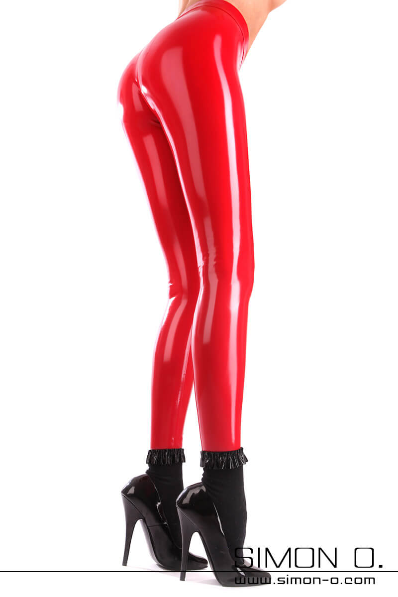 Tight-fitting, high-gloss latex leggings are worn by a slim lady with black socks and high heels.