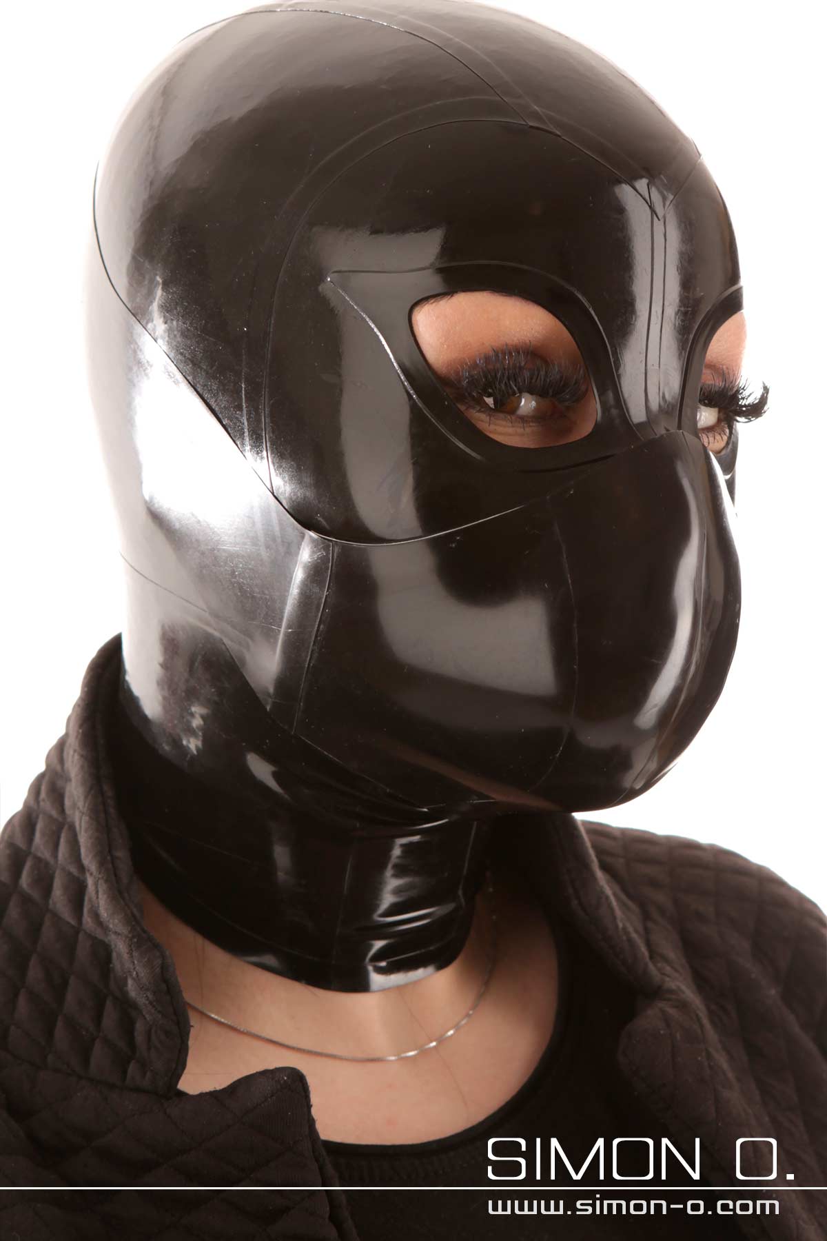 A woman with a latex mask wears a mouth and nose protection in black over her latex mask.