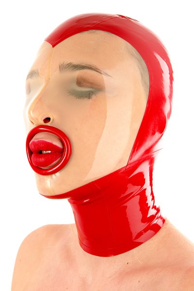 A woman wears a shiny red latex blowjob mask with a fellatio ring. The tight-fitting mask has a transparent face section with closed eyes. The bright red painted lips harmonise with the colour of the mask and create an impressive visual effect.