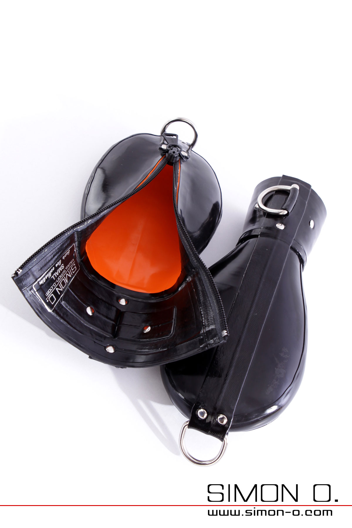 Close-up of black latex bondage mittens with D-rings and lockable zipper on a white background.