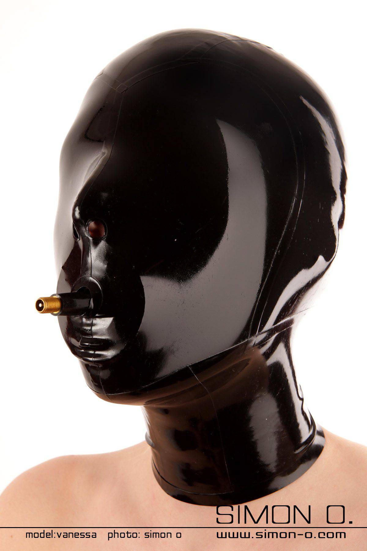 A women wears a tight shiny Blindfold slave latex hood with gag in black