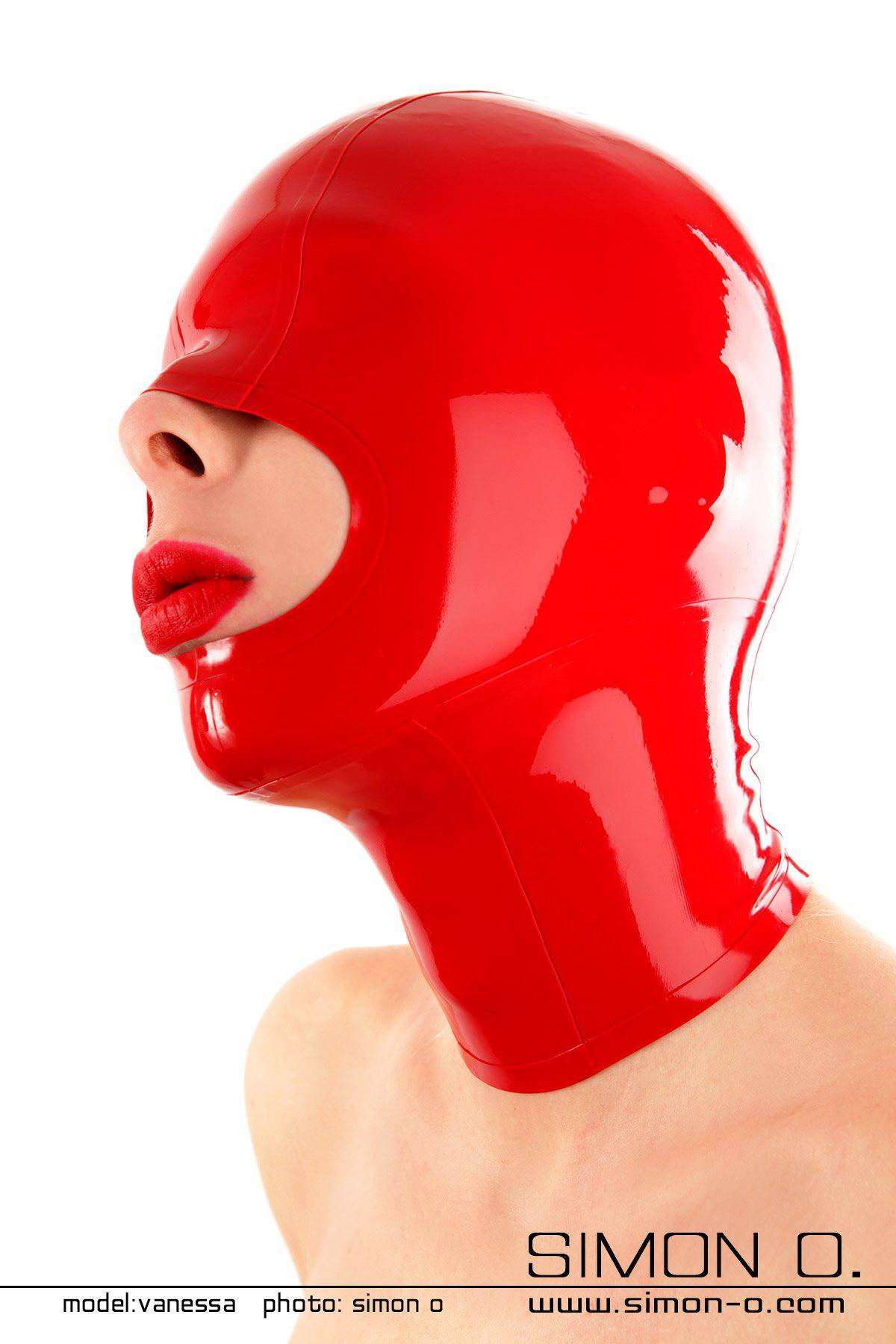 A red shiny latex mask with closed eyes and large opening for the mouth