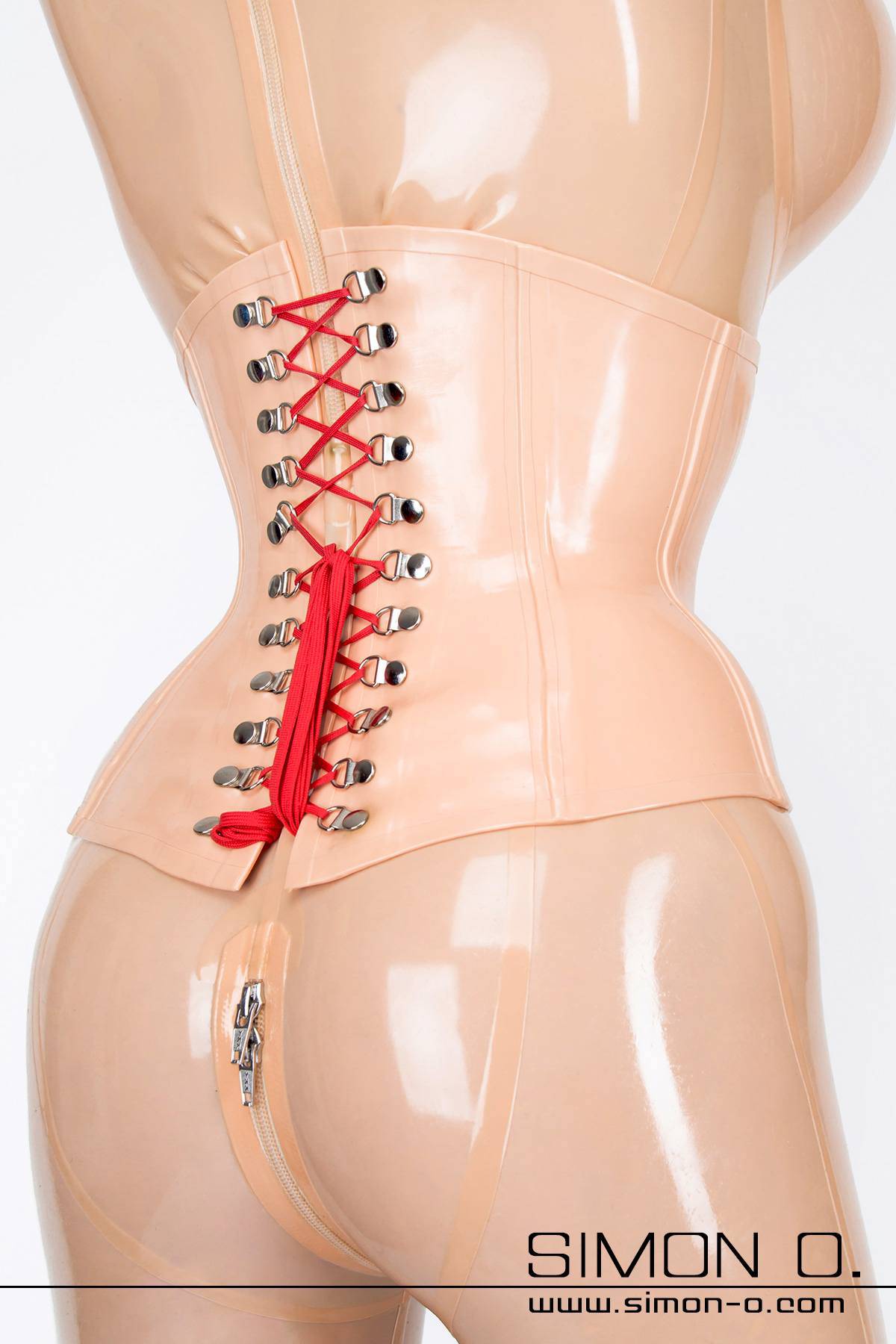 A tightly laced latex corset with skin colored with red lacing