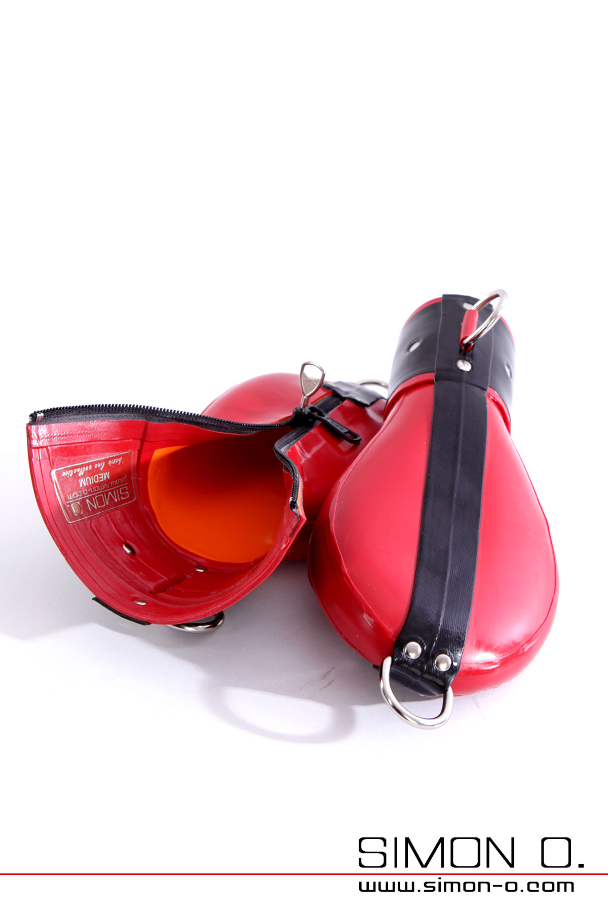 Red black latex bondage mittens with chrome rings and lockable zippers on a white background.