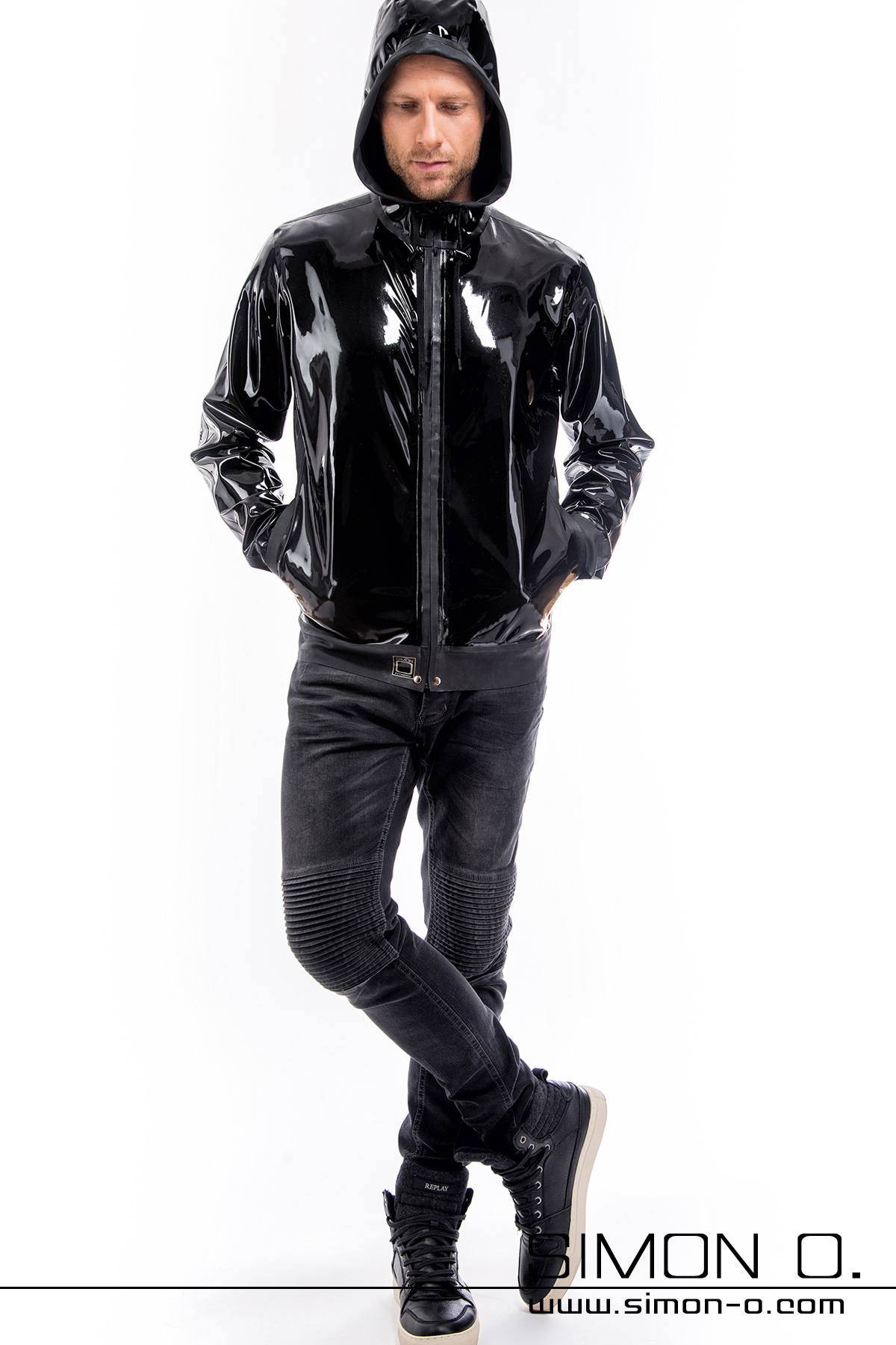 A man wears a latex jacket with hood in black