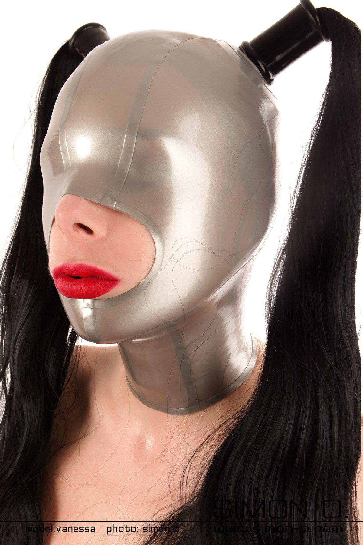 One person is wearing a smooth, metallic-looking latex mask hood with two black ponytails falling down. 