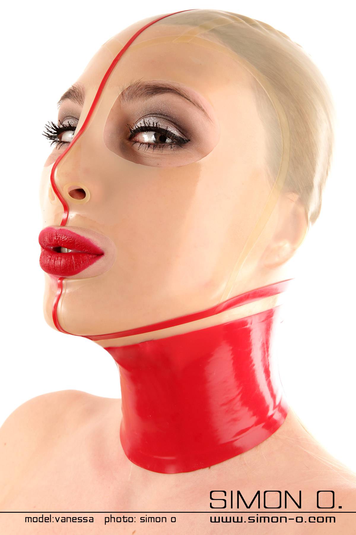 A person wears a shiny, tight-fitting latex mask in red and transparent, with a nylon face look.