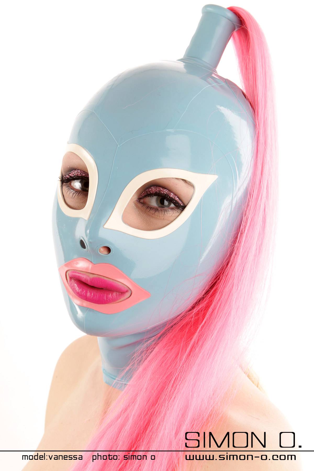 Light blue latex mask with white cat's eyes and a pink-rimmed mouth. The mask is complemented by a long pink ponytail.